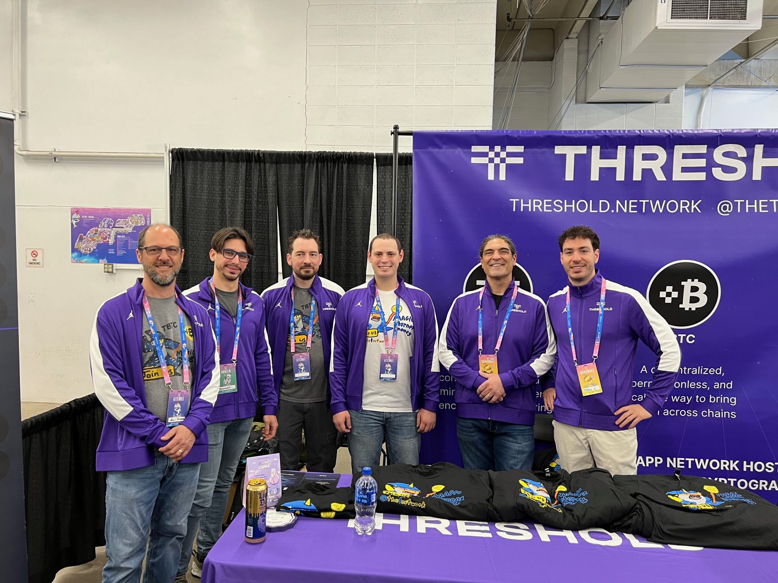 Nico with the Threshold team at a conference booth